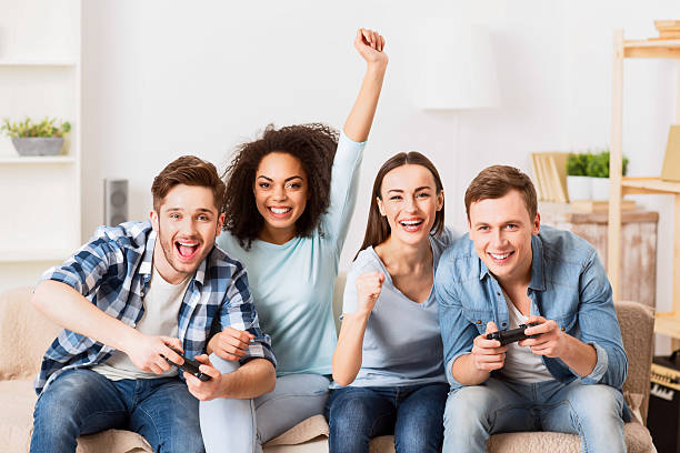istock Cheerful friends playing video games 522367562