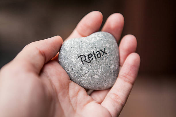 istock Inner balance concept: hands holding stones with the word relax 522368446