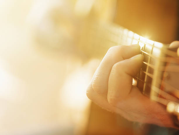 istock Dreamy, soft-focus hands of a sunlit young guitarist 522369478