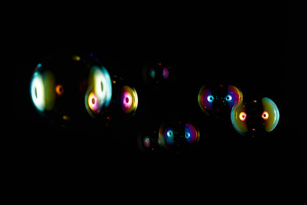 istock Colorful soap bubbles isolated on black background 522369798