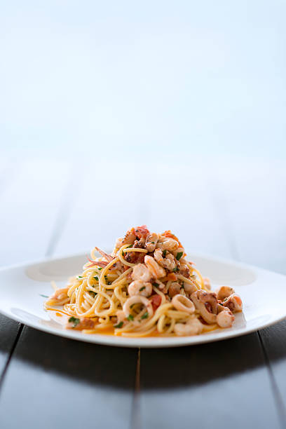 istock Spaghetti with Mixed Raw Seafood Plate by the Sea 522370540