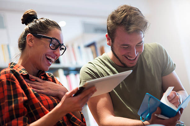 Having fun and studying Two university students preparing for exam and smiling bookstore book library store stock pictures, royalty-free photos & images