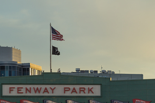 Boston, United States - September 21, 2015: An American flag flies over Fenway Park at sunset.