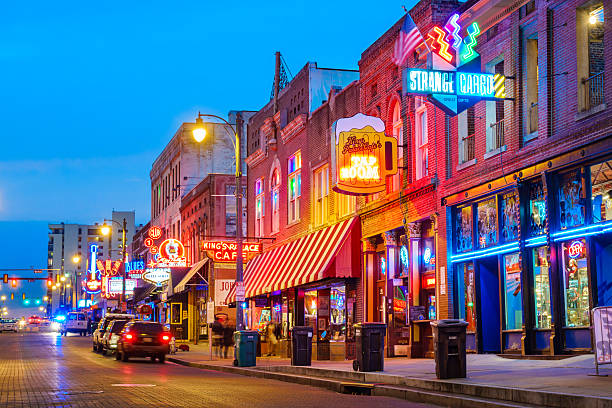 Beale Street Music District in Memphis Tennessee USA Photo of colorful cafe bars at the iconic Beale Street music and entertainment district of downtown Memphis, Tennessee, USA, illuminated at night. beale street stock pictures, royalty-free photos & images