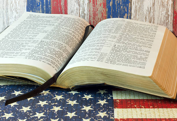 istock Old Holy Bible and the American Flag 522374560