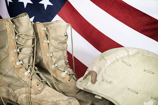 istock Old combat boots and helmet with American flag 522374902