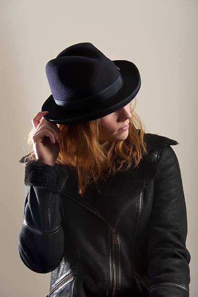 istock Redhead touching brim of blue felt hat 522377239