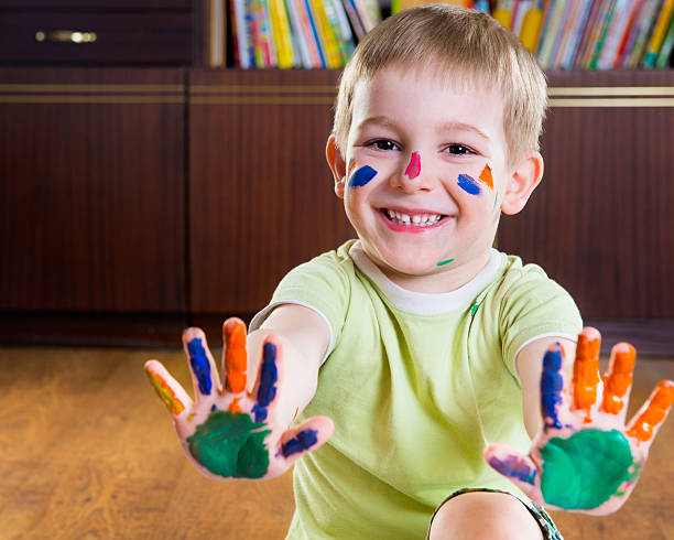 istock Smiling little boy showing his hands in paints 522377423