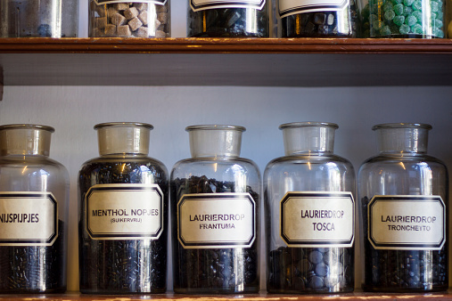 A shelf of glass jars full of licorice in a traditional Dutch pharmacy--used as medicine and candy.