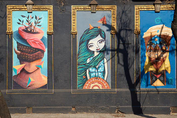 Santiago, Сhile - August 12, 2014: Colourful murals decorating the streets of Barrio Yungay in Santiago, capital of Chile. Murals are common in many urban areas of Chile and are often used as a means of expressing political views.