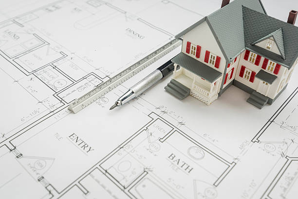 istock Model Home, Engineer Pencil and Ruler Resting On House Plans 522378534