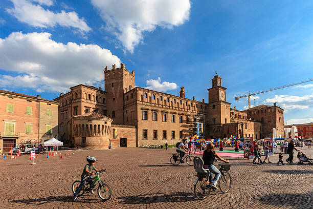 Carpi, Italy - September 22, 2013: People stroll in the big Piazza dei Martini in a Sunday of September, while children enjoy the outdoor games.