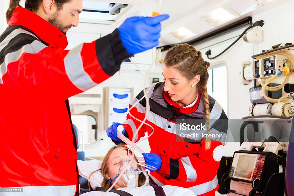 Ambulance helping injured woman on stretcher Emergency doctor and nurse or ambulance team transporting accident victim on stretcher Paramedic Stock Photo