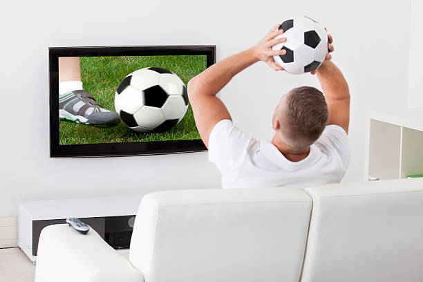 istock Soccer fan watching a game on television 522379705