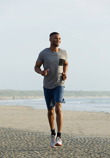 istock Young african american man smiling and running 522380459