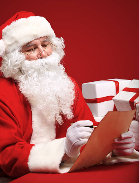 istock Santa Claus looking at envelope in his hands 522380481