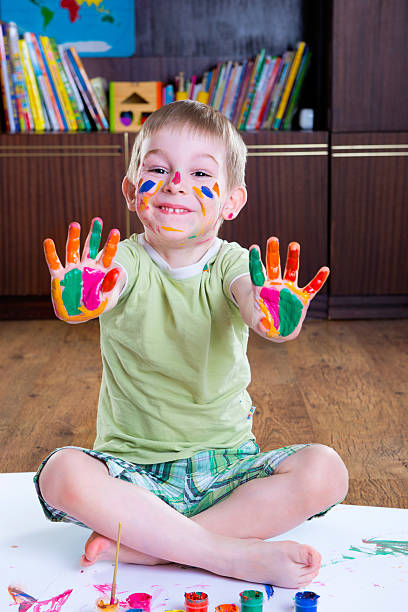 istock Cute little boy showing his colorful palms 522380705