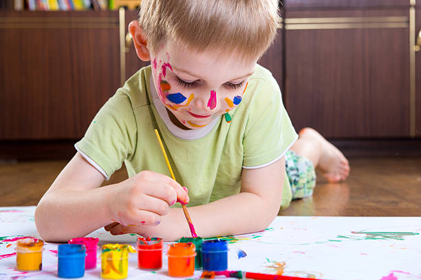 istock Excited little boy painting 522380709