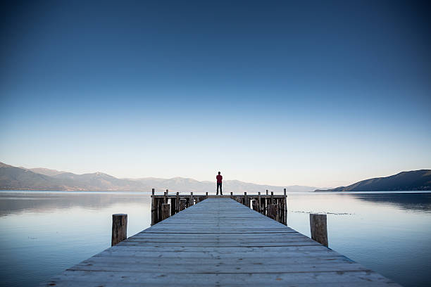 Relax Man has relaxing in beautiful landscape on pier at sunset in lake Ohrid,Macedonia. jetty stock pictures, royalty-free photos & images