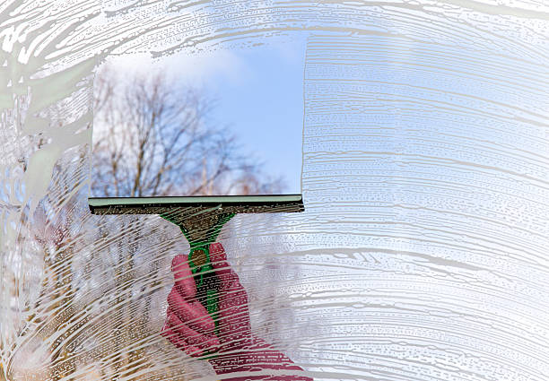 istock Early spring windows cleaning. Maid cleans window. 522382344