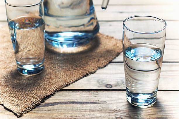 Glasses of water on wooden table. Selective focus. stock photo