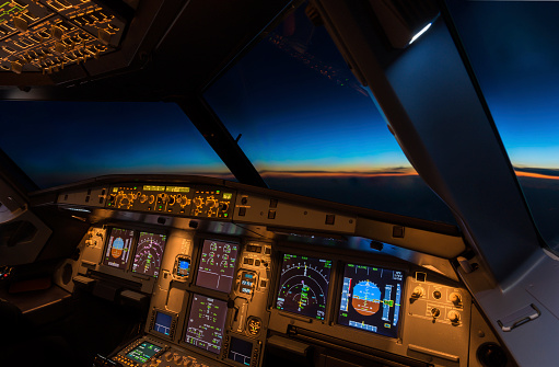 Jet aircraft cockpit at twilight time.