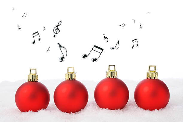 istock Four red Christmas balls on the snow with musical note 522382711
