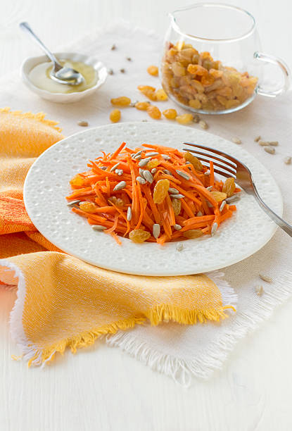 Carrot salad with raisins, sunflower seeds and honey