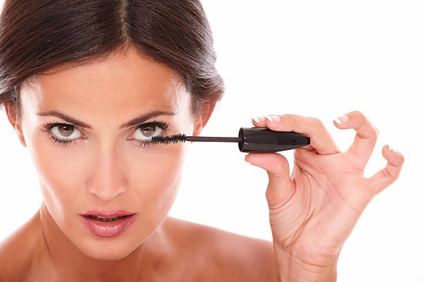 istock Young latin woman using mascara to her eyelash 522382749