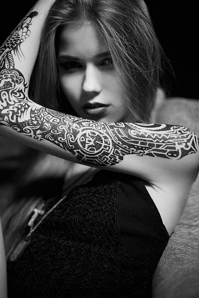 istock Pretty female with tattoos looking at camera 522382903