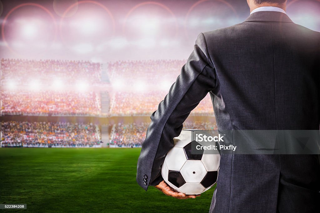 soccer manager against supporters in the stadium back view of soccer manager against supporters in the stadium Soccer Stock Photo