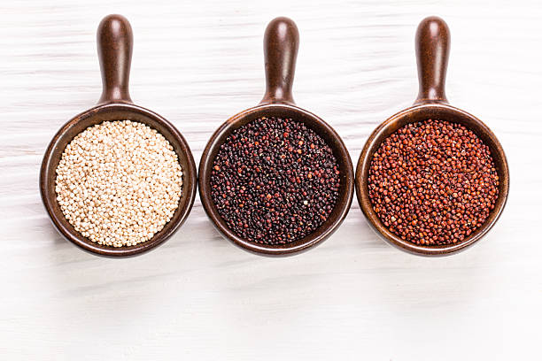 istock Red, black and white quinoa seeds on a wooden background 522384260