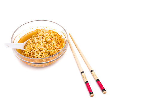Bowl of convenient but unhealthy instant noodle with sodium flavored soup on white background