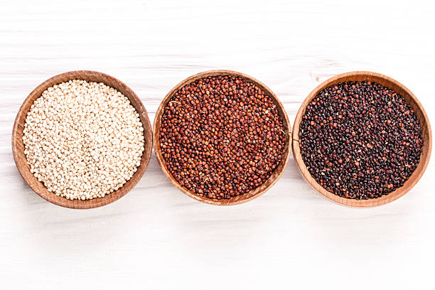 istock Red, black and white quinoa seeds on a wooden background 522384320