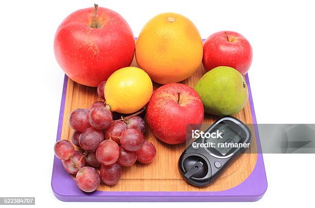Fresh Natural Fruits With Glucose Meter On Cutting Board Stock Photo - Download Image Now