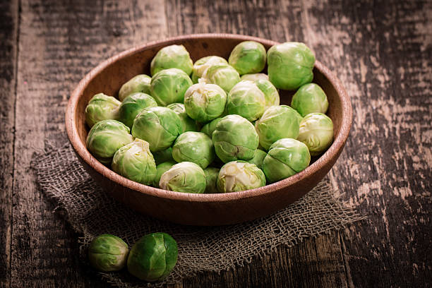 istock Fresh brussel sprouts over rustic wooden texture.healthy food 522388634