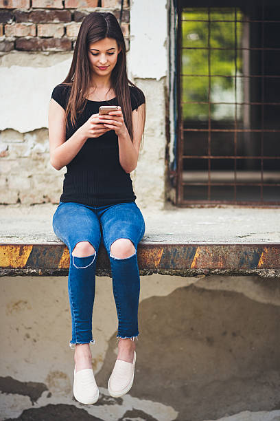 istock young woman with smart phone 522389192