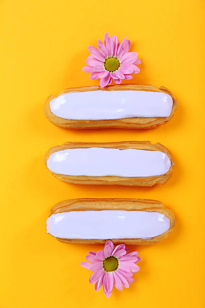 Eclairs with glaze on a paper background