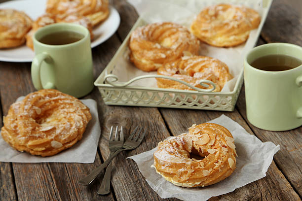 istock Sweet eclairs on a grey wooden table 522391174