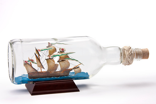 There are several ways to put a ship inside a bottle. The simplest way is to rig the masts of the ship and raise it up when the ship is inside the bottle. Masts, spars and sails are built separately and then attached to the hull of the ship with strings and hinges so the masts can lie flat against the deck. The ship is then placed inside the bottle and the masts are pulled up using the strings attached to the masts.