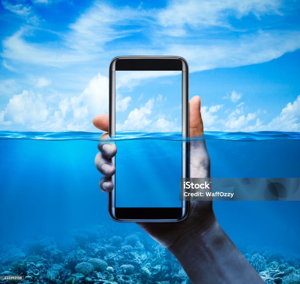 Mobile phone water-resistant with background half of the Mobile phone under water, water-resistant scene Underwater Stock Photo