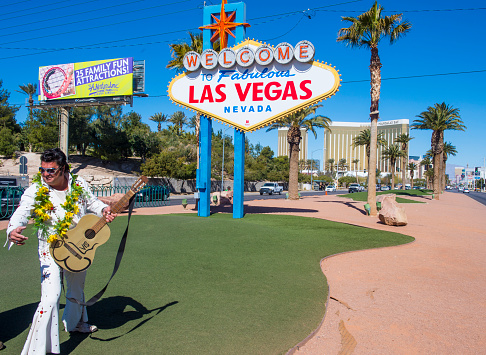 Las Vegas , USA - February 26, 2013 :  Actor dressed as Elvis near the Welcome to Las Vegas sign