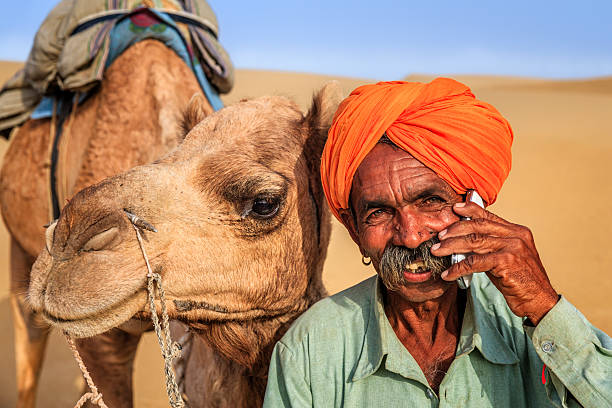 istock Indian man using a mobile, desert village, India 522396158