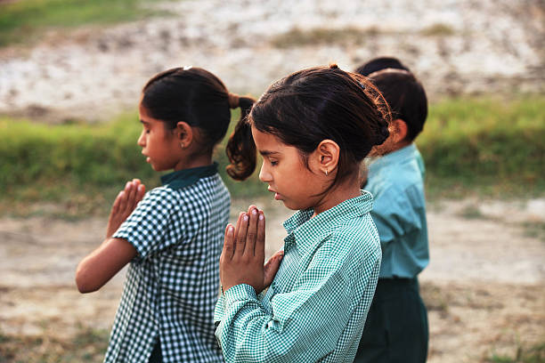istock Children praying in the Nature 522396648