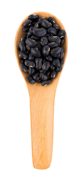 istock black bean in the spoon on white background 522397322