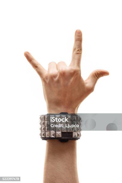 Vertical Shot Of A Hand Making Rock Sign Stock Photo - Download Image Now - Rock Music, Bracelet, Symbol