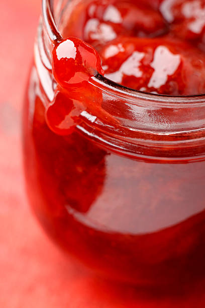 istock Strawberry jam blob over glass jar screw 522398318