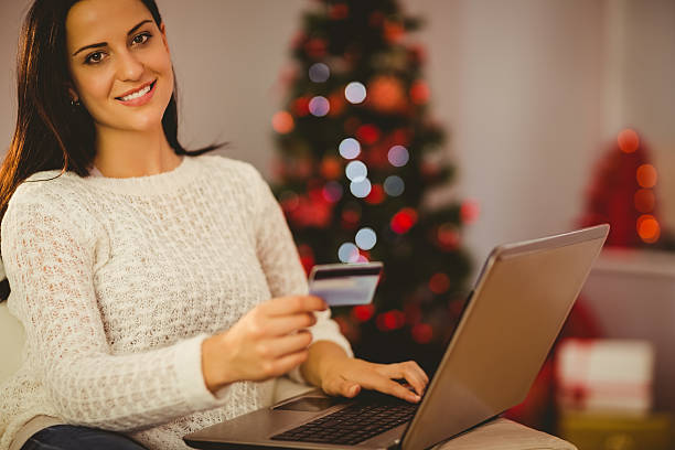 istock Pretty brunette shopping online at christmas 522398499