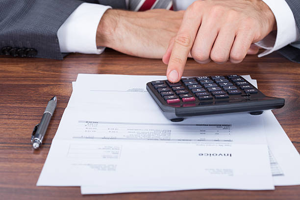 istock Businessman Calculating Invoice On Desk 522398509