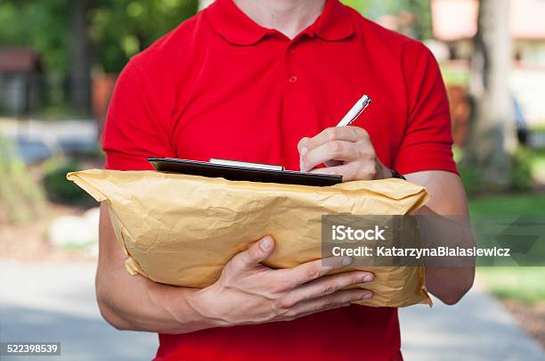 Delivery Guy Does His Paperwork Stock Photo - Download Image Now - Carton, Filling, Adult
